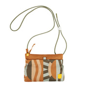 Small fabric crossbody bag with abstract earthy pattern and green rope strap, set against a white background.