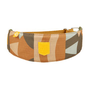 Wide dog collar with a geometric brown, tan, and green pattern, and a yellow Woolly Wolf patch.