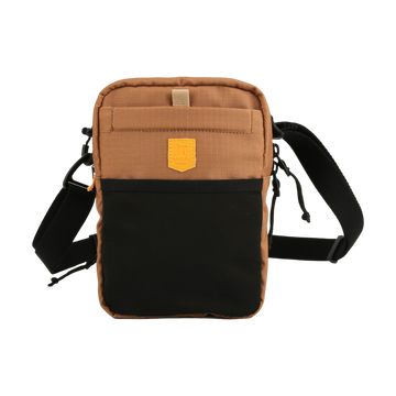 Small brown and black crossbody bag with adjustable strap and front pocket against a white background.