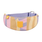 Wide fabric dog collar with pastel pink, beige, and purple geometric patterns and a yellow Woolly Wolf logo patch.