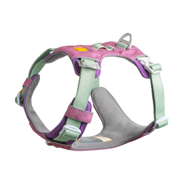 Pink, purple, and mint green padded dog harness with adjustable straps and metal leash attachment.